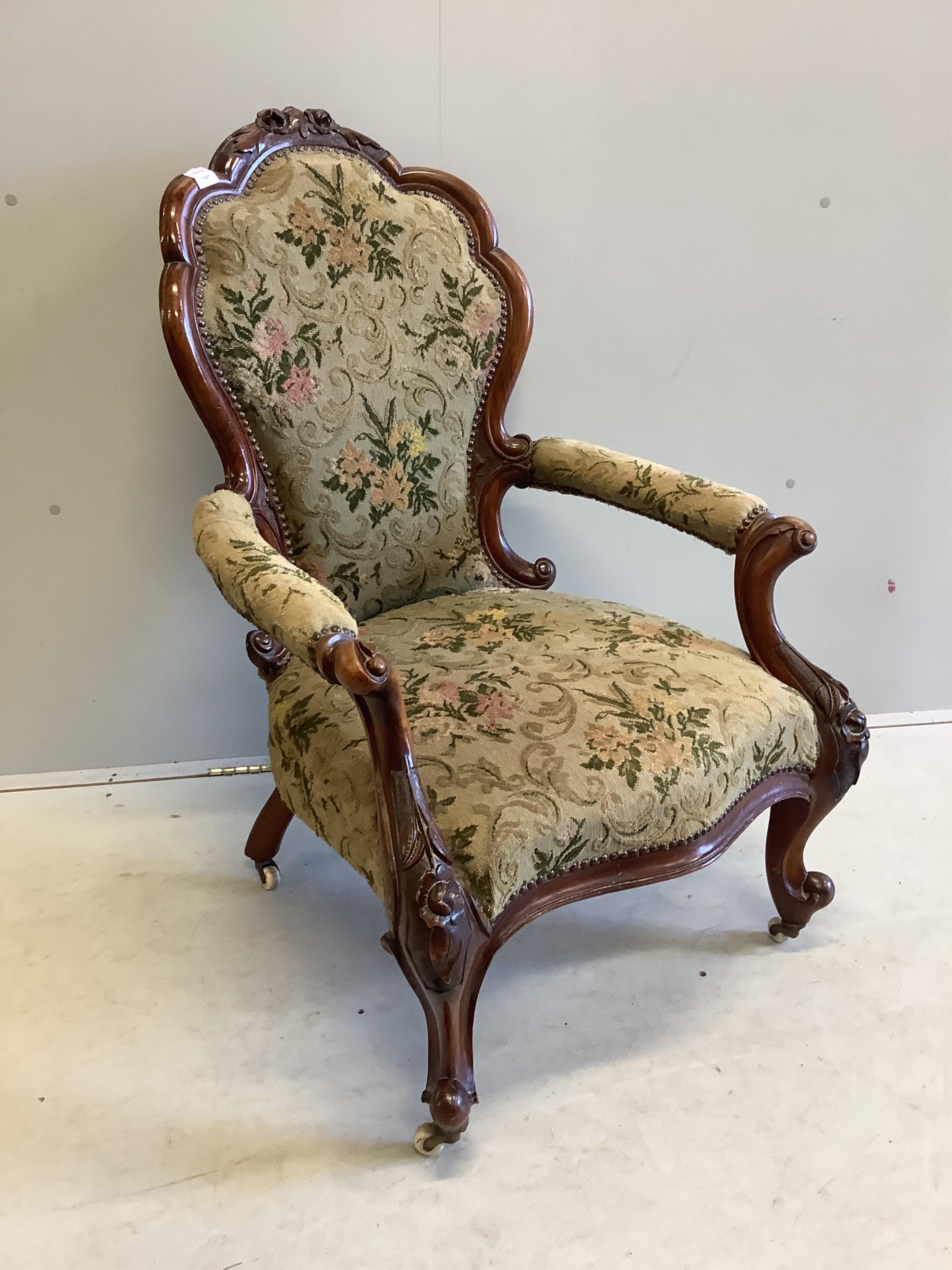 A Victorian walnut upholstered open armchair, width 66cm, depth 60cm, height 100cm. Condition - good